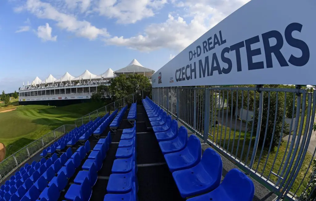 Tribuna na turnaji D+D REAL Czech Masters 2024 s výhledem na golfové hřiště PGA National OAKS Prague, připravená na oslavu 10. výročí turnaje.