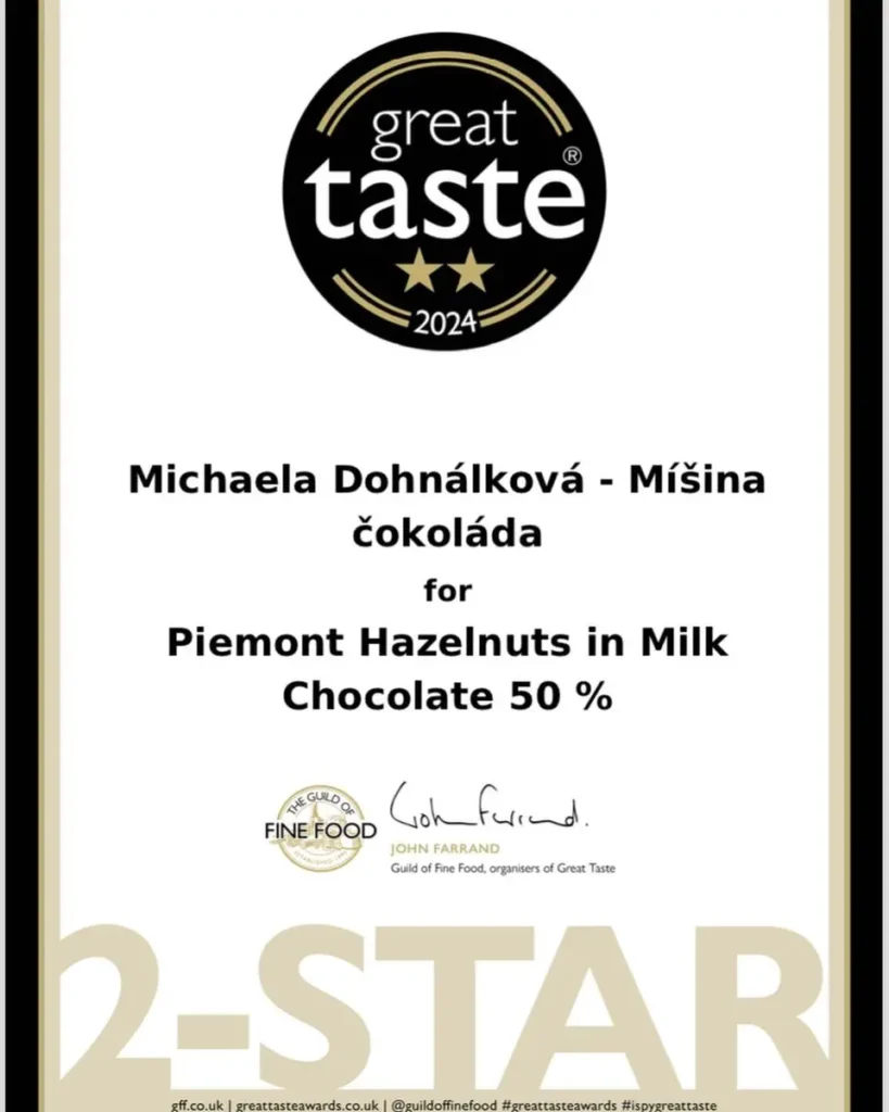 Certifikát z prestižní soutěže Great Taste Awards 2024 udělený Michaele Dohnálkové a její značce Míšina čokoláda za produkt Piemonstské lískové oříšky v mléčné čokoládě 50 %. Čokoláda získala ocenění dvou hvězd za výjimečnou kvalitu a chuť.