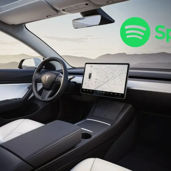 Interiér vozu Tesla Model Y s centrálním displejem a logem Spotify, zobrazující minimalistický a moderní design s pohodlnými sedadly a velkou dotykovou obrazovkou.