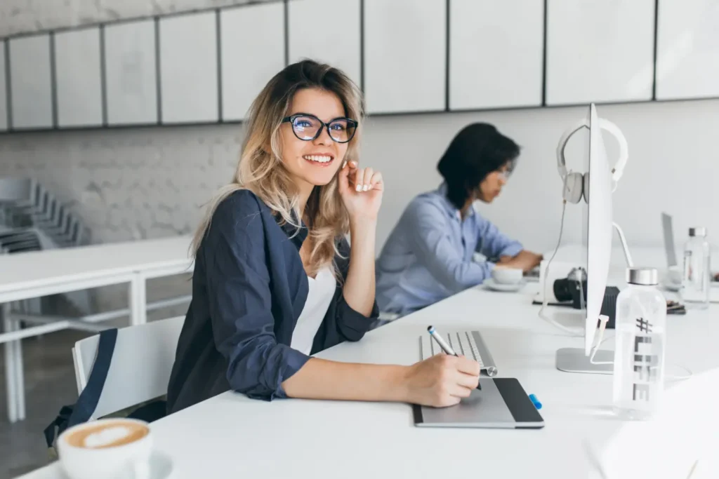 Krásná žena pracuje na počítači iMac a její Mac chrání VPNka.