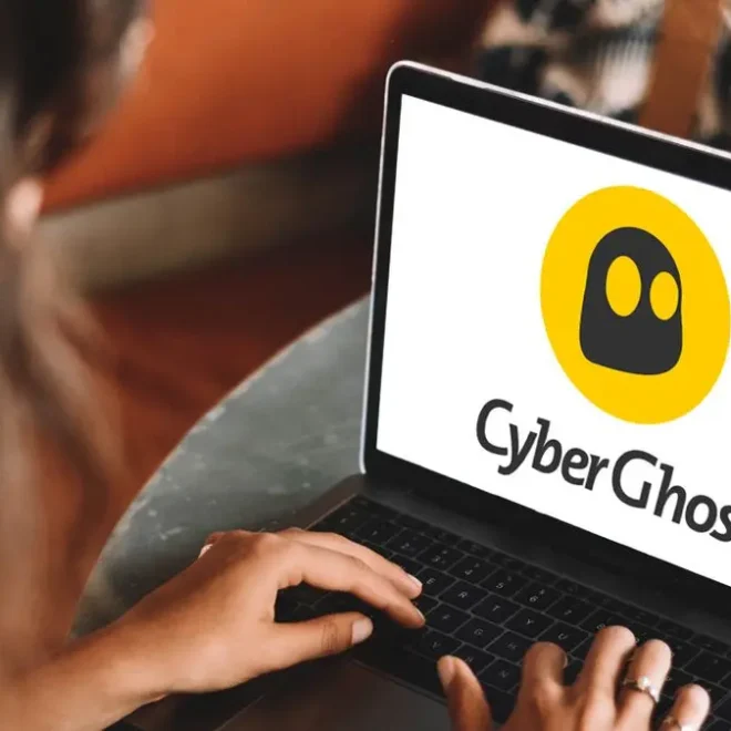 Osoba používající CyberGhost VPN na notebooku, na jehož obrazovce je zobrazeno logo CyberGhost. Ilustrační fotografie zobrazující VPN v akci.